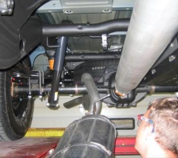 vehicle by lifting the tailpipe over the rear axle and