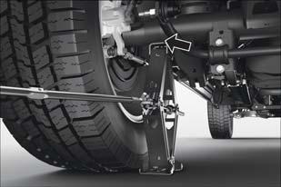 Place the jack under the axle between the wheel and the shock bracket with the extension with the jack hook extending to the rear. Rear Jacking Location Connect the extension tubes and lug wrench.