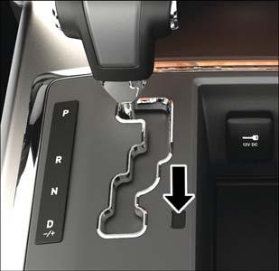 Using a small screwdriver or similar tool, remove the gear selector override access cover (located to the right of the gear selector). 4.