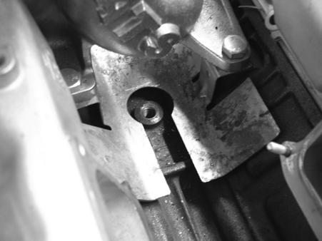 21. Install the new oil line into the block with the line pointing towards the front of the engine, following the cut out of the heat shield, using the old banjo bolt and crush washers.