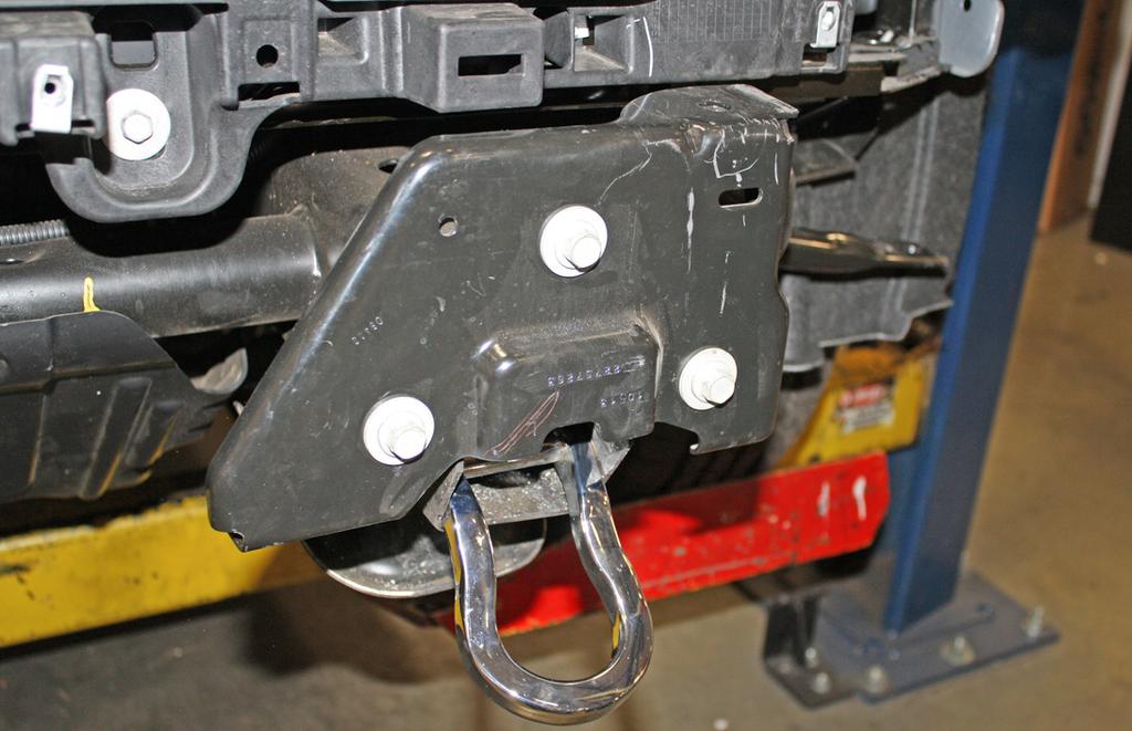 On the outside of the frame rail, insert one of the supplied ½" x 5" bolts through one of the ¼" x 1¼" x 2¾" backing plates (with two 9/16"