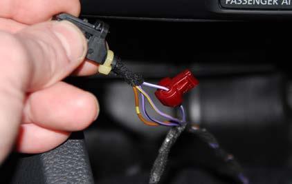 Step 32: Slip Joint Pliers, Razor blade Carefully trim back about an inch of electrical tape from the wires for the start button, then install the red T-tap onto the Purple/White wire.