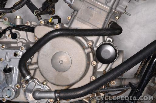 Connect the cylinder coolant hose to the water pump. Install the hose clamp and tighten it securely with a #2 Phillips screwdriver. Fill the engine oil. See the Engine Oil topic for more information.