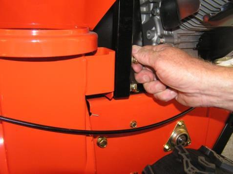 Install discharge chute over opening in the auger