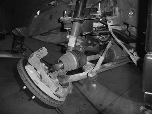 Figure 10 20. Remove the lower ball joint nut and thread back on by hand one or two turns. Strike the knuckle near the ball joint to release the taper.