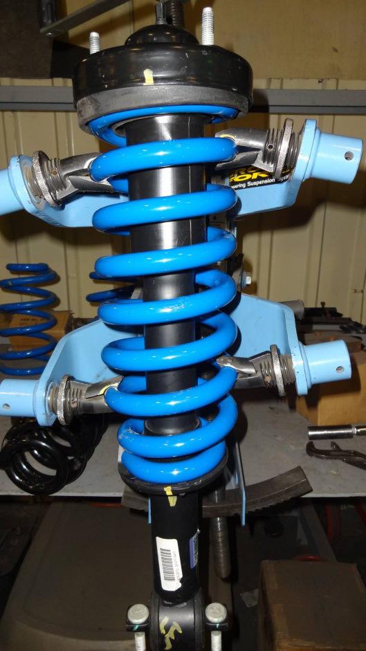 F. ONCE THAT YOU ARE SURE THE COIL IS LOCATED CORRECTLY ON THE STRUT REMOVE THE STRUT/COIL ASSEMBLY FROM THE COMPRESSOR. FOLLOW THE STRUT COMPRESSOR INSTRUCTIONS. G.