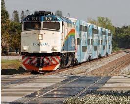 Commuter Rail Locomotive pulling passenger cars Shares freight tracks Flexible