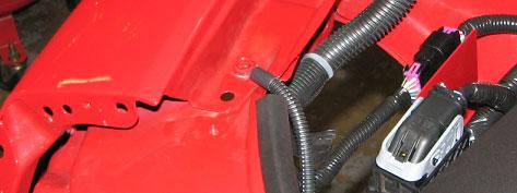 Carefully route the Passenger Side PCV Hose to the fitting on the underside of the silicone air inlet tube so as to avoid