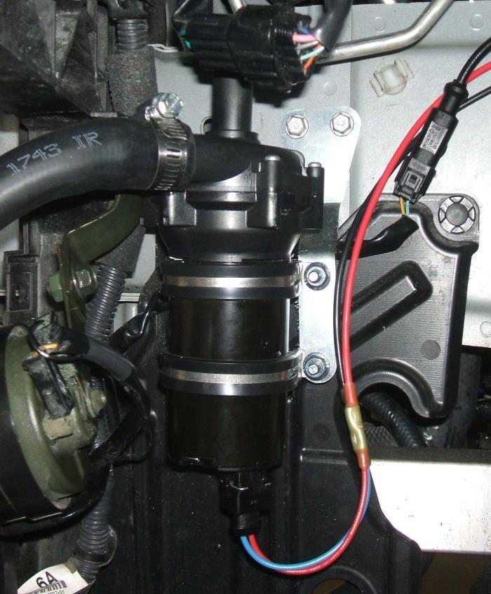 Feed the 3/4" end under the blower to the top of the pump and secure that end with a clamp. Mount the tank to the 2 holes in the sheet metal surrounding the master cylinder compartment. 4.