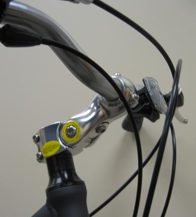 To install the handlebar-mounted front reflector (white), remove the reflector mounting screw and gently open the bracket enough to slide over the handlebar on the left side of the stem (8-B).
