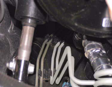 2. Carefully pull brake lines from