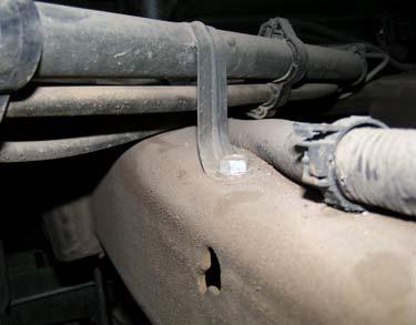 Attach locking pliers to parking brake cable to allow slack, if necessary. b. Use expanding pliers to disconnect parking brake cable from junction.