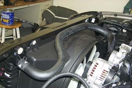 Remove heater hoses from clip on passenger side.