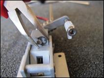 Grind two flat spots on the center mark of the strut where the axle needs to be secured to the
