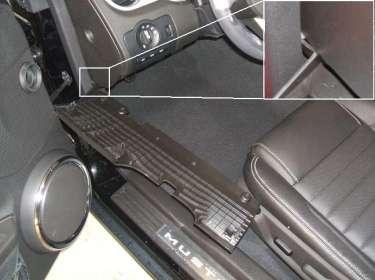 Remove two (2) screws from the bottom edge of the lower steering column cover.