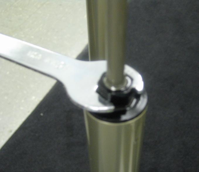 Turn the fork upside down and using a 15mm open end wrench, unthread the rebound damping assembly from the bottom of the stanchion.