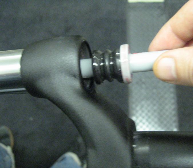 Lightly grease the spring and install into stanchion leg. Install the preload adjuster into the fork leg. Tighten down using a 0mm socket to 5,1-6, Nm (45-55 in. lbs).