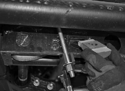 Adjust the torsion bar key up high enough so that the small metal adjusting block and bolt can be removed.