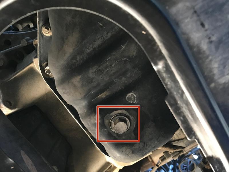 Locate the 14 mm hex oil drain plug. The drain plug is underneath the truck in the middle of the plate after the skid plate.