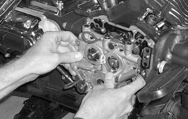 12. Installing outer sprockets and drive chain. a. While holding rear cam sprocket vertically in one hand, place drive chain over sprocket with timing mark pointing down.