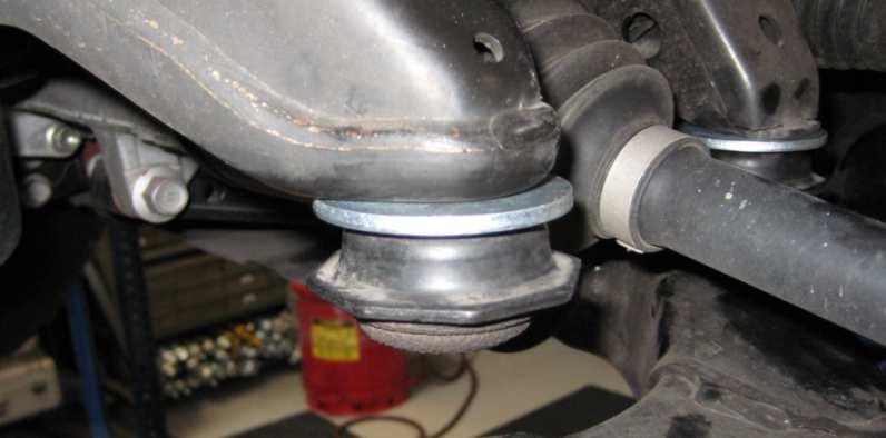Rotate the shock so that the lower mount is aligned with the upper mount studs as noted in step B. K. Install the supplied upper bushing and supplied upper washer (concave side down) as shown.