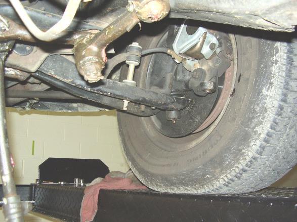 Remove the cotter pins and nuts from outer tie rod ends and remove