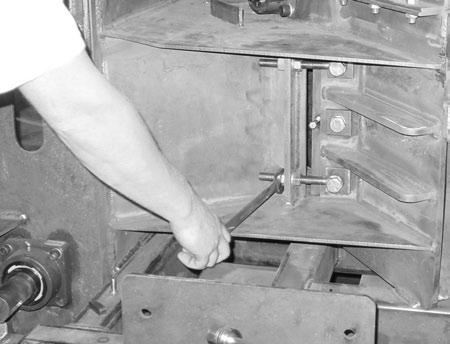 12 CHIPPER SERVICE CUTTER SYSTEM Loosen the nuts on the adjustment bolts that are on the far side of the plate (as shown). There are two adjustment bolts.