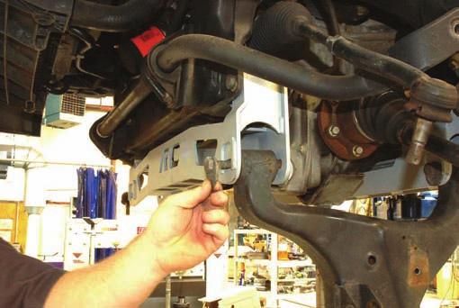 37. Install control arm on truck using supplied cam bolts and hardware. Photo 32. 38. Remove bump-stop off of control arm using 12mm wrench. Install bump-stop to the new bump-stop ext.