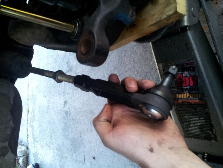 Pop the new outer tie rod end into the spindle, take the new castle nut and tighten it into place where the hole from the stud and