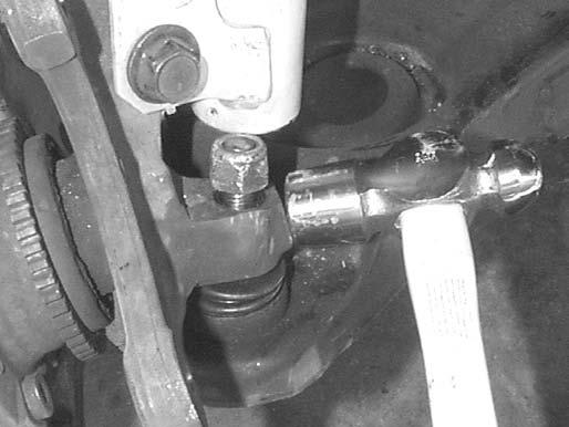 Remove the nut from the tie-rod and detach the tierod end from the steering arm. 22.