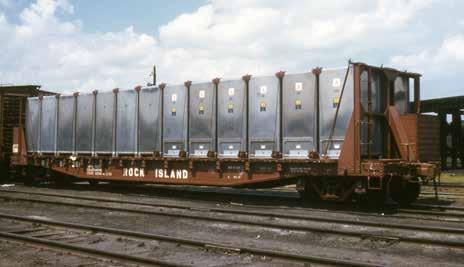 A pair of new Railway Express Agency delivery trucks are themselves being delivered on a 50-foot Seaboard flatcar in 1958. The flatcar was built in 1940. J.