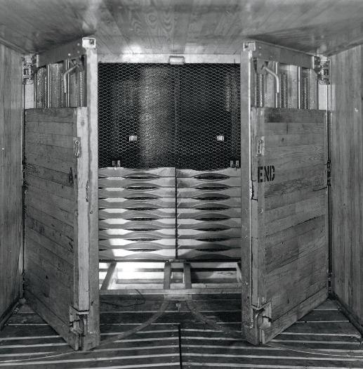 They slide blocks of ice to the tops of refrigerator cars and then chop it as it goes through the hatches into the bunkers.