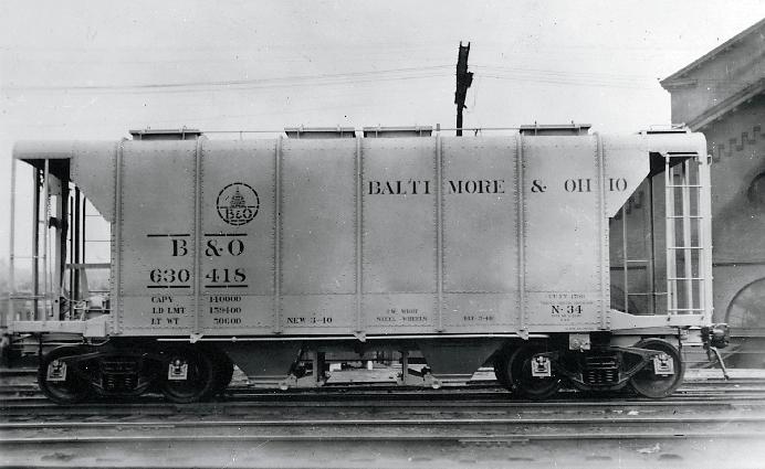 Dry bulk material requiring protection, such as cement, lime, foundry sand, grain, and flour, were initially packed into sacks or barrels and carried in conventional boxcars.