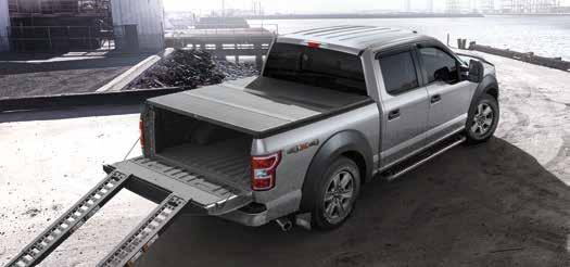 A B C D XLT SuperCrew 4x4 in Ingot Silver accessorized with a chrome exhaust tip, heavy-duty splash guards with stainless steel inserts, step bars, stowable load ramps, spray-in bedliner, hardfolding