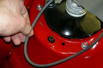 Using a pair of pliers, grasp the end on the transmission tension