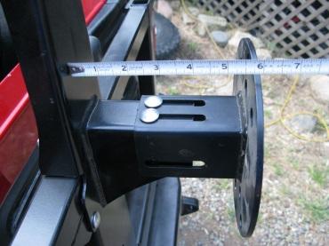 Measure from the antenna post to the front side of the wheel hub.