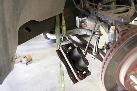 Remove brake caliper bolts at the spindle,