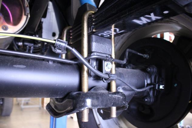 Use the floor jack to lift the rear axle, keeping the pin aligned, and install the new ubolts and
