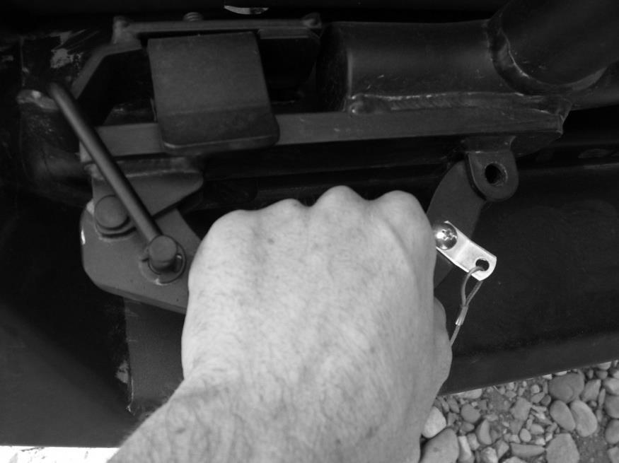 V. Tire Carrier Operation Installation Instructions A. To open the latch mechanism, remove spring lock pin, firmly grasp handle, and rotate as shown below to release compression on the latch bumper.