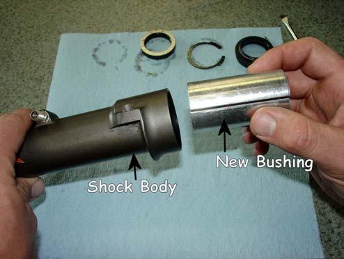 If the bushing is too tight to remove while the Shock Body is in the frame, remove it and clamp the