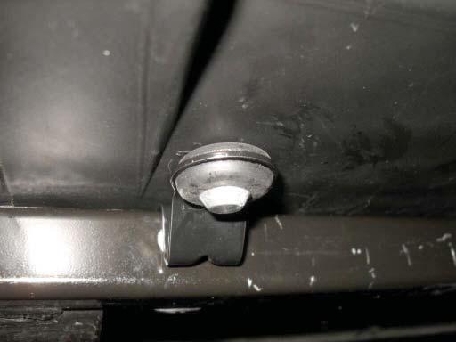 229. Close up of the mounting lug inserted through the rubber grommet in the