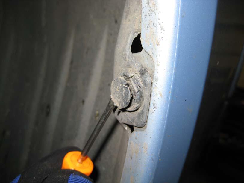 Working in the wheel arches, remove the 8mm self tapping screw at the top of the arch and the