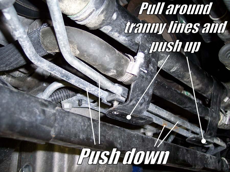 As you can see from looking at the stock sway bar location, the bar will not be able to slide out while the transmission lines are connected.