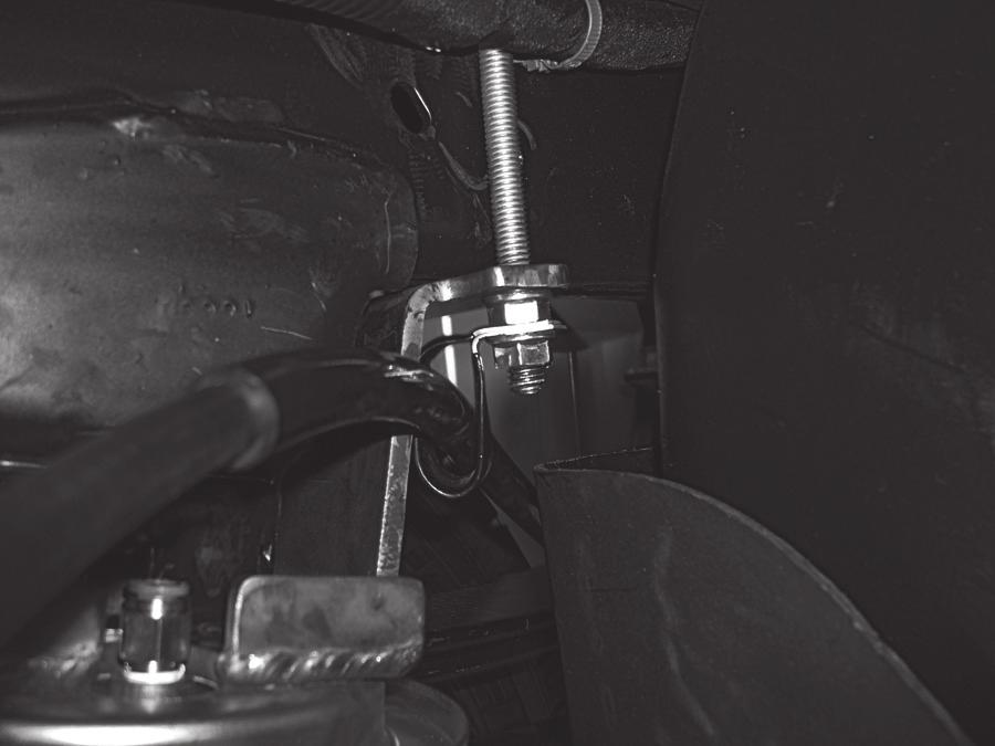 Attach the emergency brake cable removed in the getting started section with the emergency brake cable bracket (Q) and 3/8 serrated flange lock nut (P) (Fig. 10).