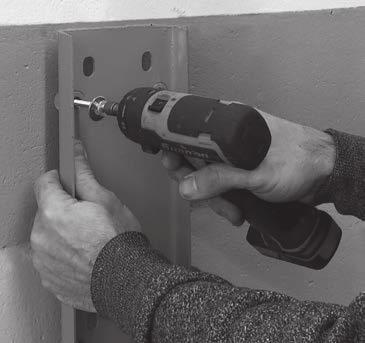 . Hammer drill holes for hollow wall anchor.