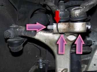 NOTE: Do NOT drive a chisel or other wedge into the grooves at the ball joint studs (red arrow).