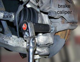 ) Step 5 - Unbolt the brake caliper Using a 21mm socket, remove the two bolts holding the brake caliper frame to the knuckle.