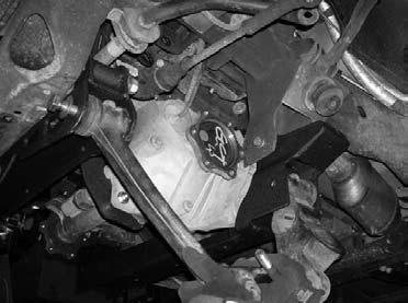 Place a hydraulic floor jack on the driver side of the front differential and carefully raise up until it makes contact with the front differential.