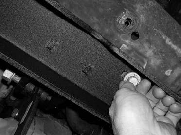 Carefully lower down on the hydraulic floor jack holding the driver side of the stock front differential until the front differential seats properly into the rear portion of the sub frame and the