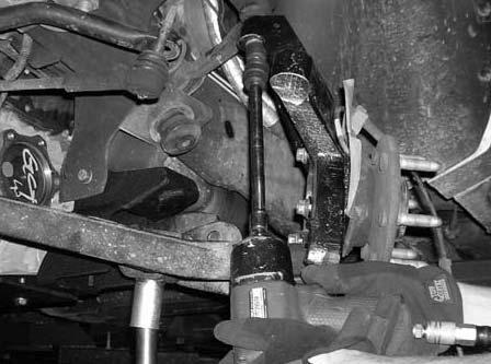 Working on the driver side, install (1) new axle spacer between the front differential and the CV axle.